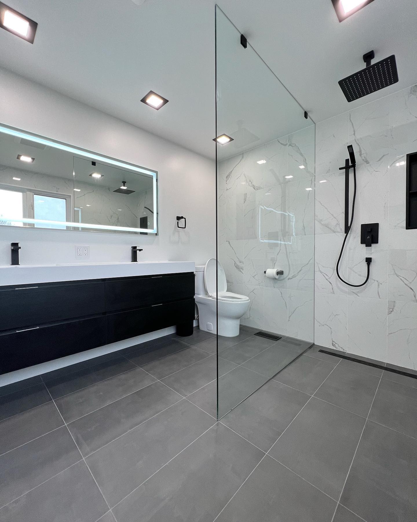 Curbless walk-in shower with matte black fixtures — Reno-eX master bathroom renovation, Elora 2022