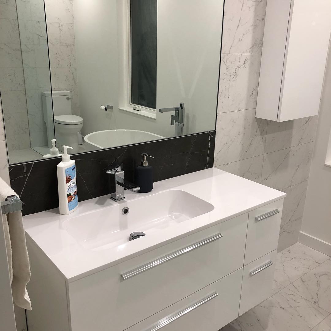 Floating vanity against black accent wall, 2019