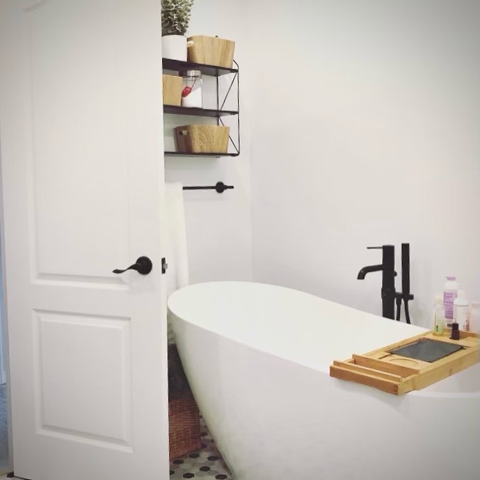 Freestanding tub with floor-mounted black faucet — Reno-eX bathroom renovation