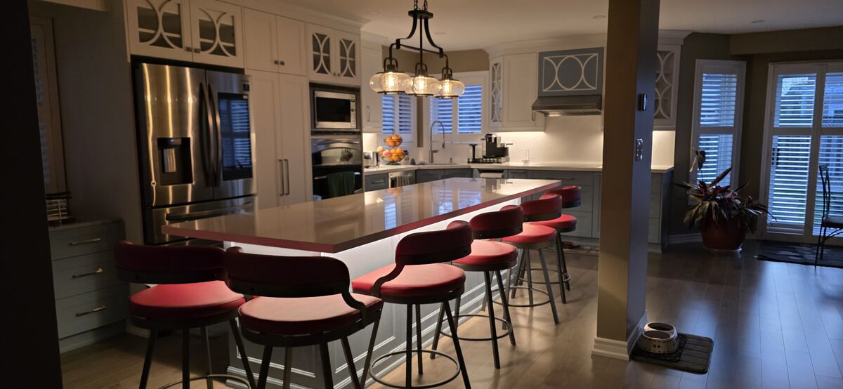 Open-concept kitchen with large island and seating after main-floor wall removal — Reno-eX, East Credit, Mississauga 2025
