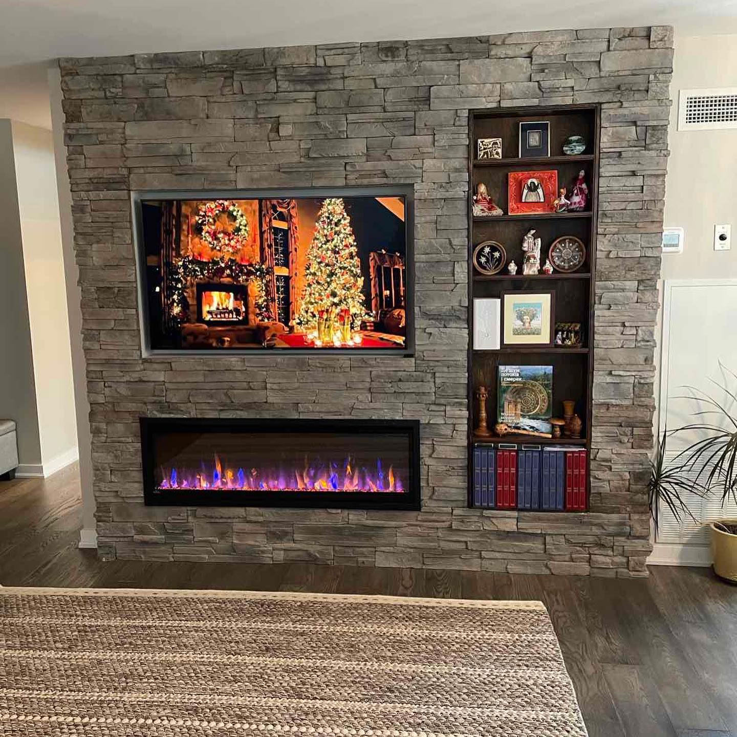Stone feature wall with built-in fireplace and shelving — Reno-eX whole-home renovation, Mississauga